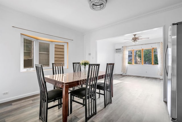 dining room with a ceiling fan, light wood-type flooring, a wall unit AC, and baseboards