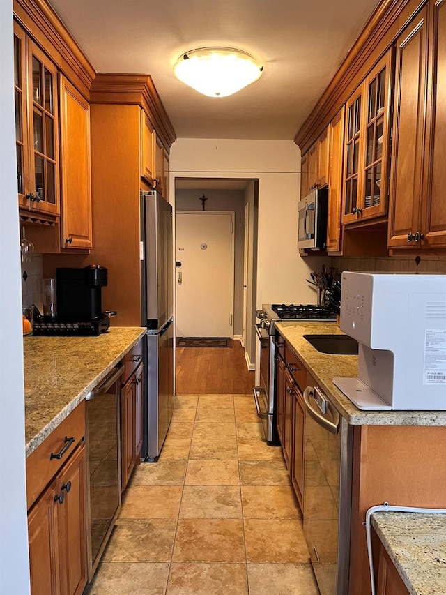 kitchen with beverage cooler, stainless steel appliances, tasteful backsplash, and brown cabinetry