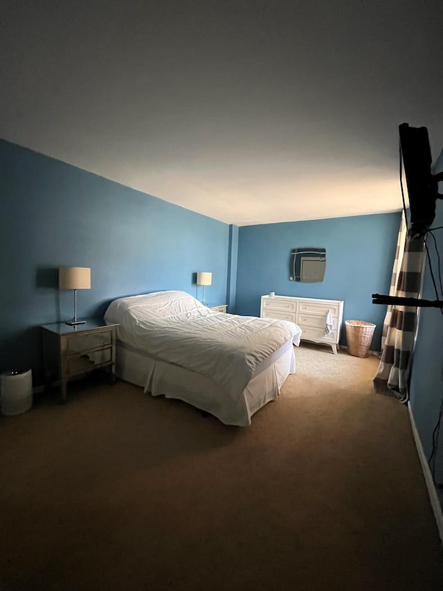 carpeted bedroom with a wall mounted air conditioner and vaulted ceiling