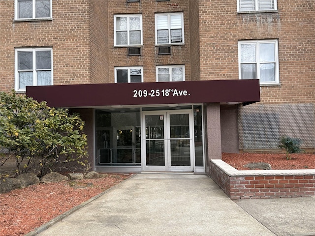 view of exterior entry featuring brick siding