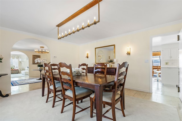 dining room featuring ornamental molding, a healthy amount of sunlight, and light tile patterned flooring