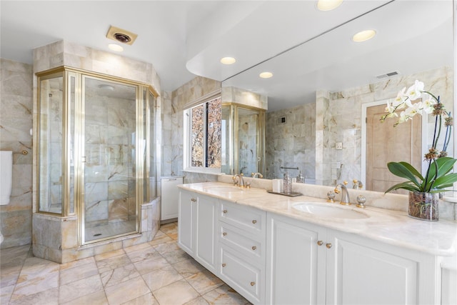 bathroom featuring a sink, visible vents, and tile walls