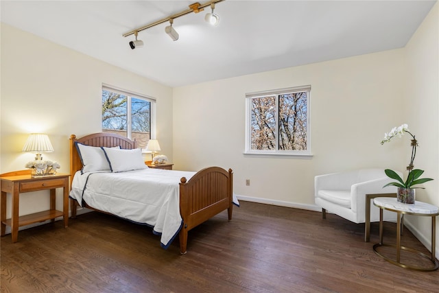 bedroom featuring baseboards and wood finished floors