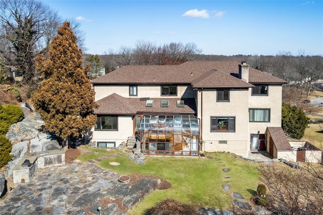 back of property featuring roof with shingles, stairway, a lawn, stucco siding, and a chimney