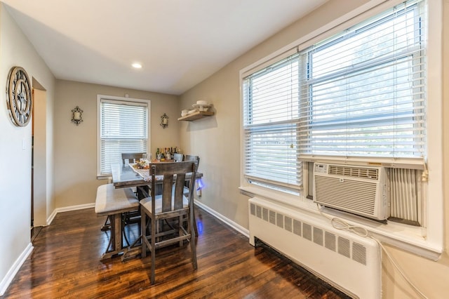 dining room featuring baseboards, plenty of natural light, dark wood finished floors, and radiator