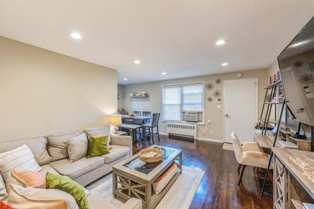 living area with cooling unit, recessed lighting, wood finished floors, baseboards, and radiator heating unit