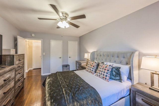 bedroom with dark wood-type flooring, baseboards, and a ceiling fan