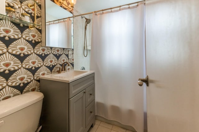 bathroom featuring shower / bath combo with shower curtain, vanity, toilet, and tile patterned floors