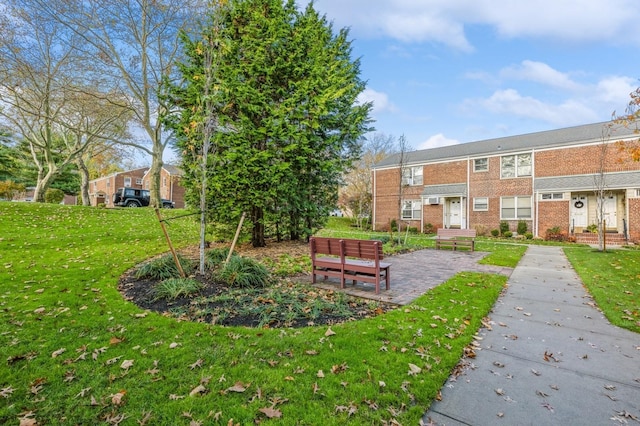 view of property's community with a lawn