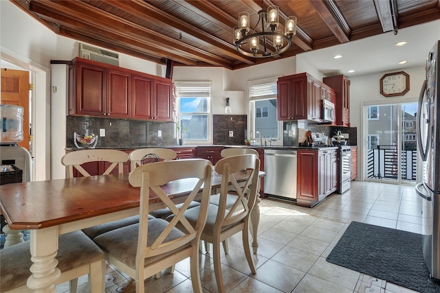 kitchen with appliances with stainless steel finishes, dark countertops, and dark brown cabinets