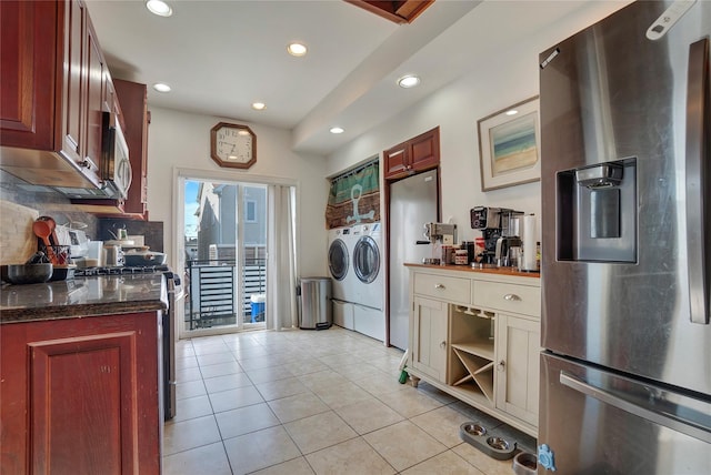 kitchen featuring light tile patterned floors, recessed lighting, stainless steel appliances, washer and dryer, and backsplash