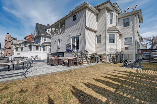 back of house with a lawn, a patio, a residential view, fence, and an outdoor living space