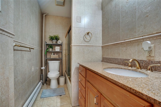 full bathroom with a shower with door, tile walls, toilet, a baseboard heating unit, and vanity