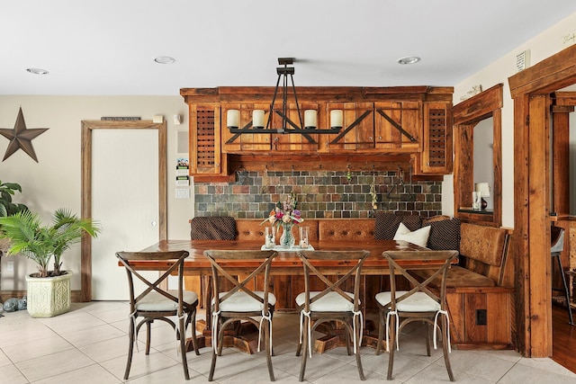 dining space featuring breakfast area, a chandelier, and light tile patterned flooring