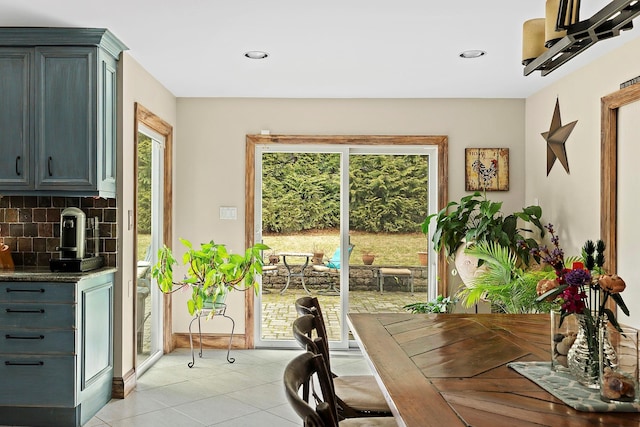 dining room featuring recessed lighting, light tile patterned flooring, a wealth of natural light, and baseboards