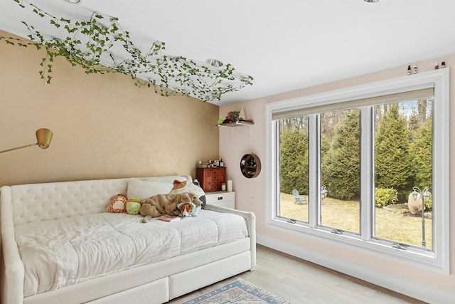 bedroom featuring baseboards and light wood-style floors