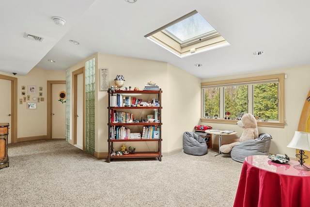 interior space with carpet, a skylight, visible vents, and baseboards