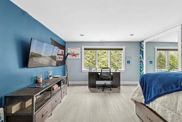 bedroom with baseboards and wood finished floors