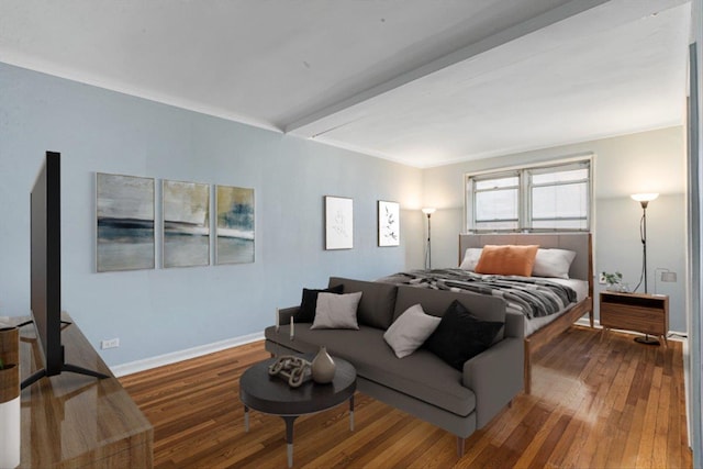 bedroom featuring beam ceiling, baseboards, and hardwood / wood-style floors