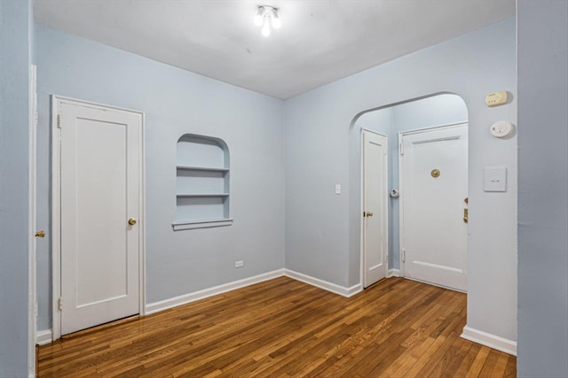 entrance foyer with hardwood / wood-style floors and baseboards