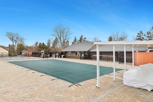 pool featuring a patio and fence