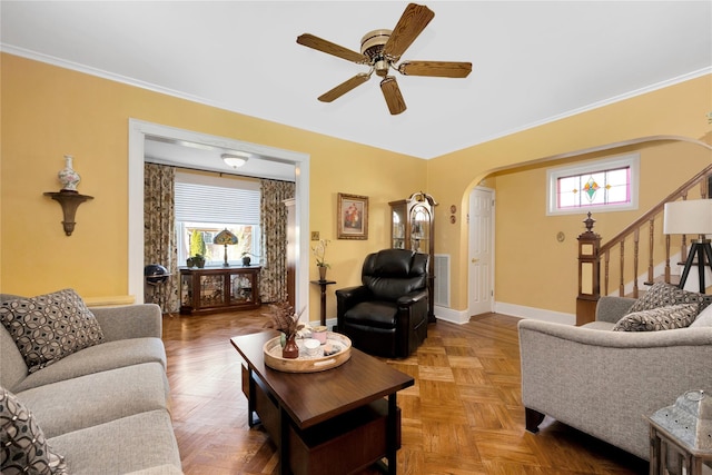 living room featuring arched walkways, ornamental molding, stairs, and baseboards