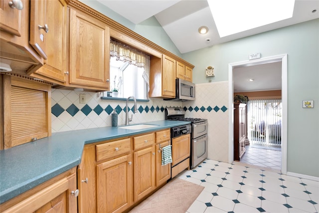 kitchen featuring tasteful backsplash, lofted ceiling with skylight, appliances with stainless steel finishes, light floors, and a sink