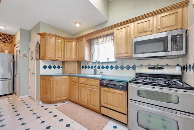 kitchen featuring light floors, tasteful backsplash, stainless steel appliances, and a sink