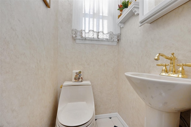 half bath with a sink and toilet