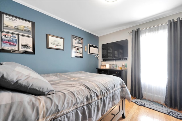 bedroom featuring light wood-style flooring and crown molding