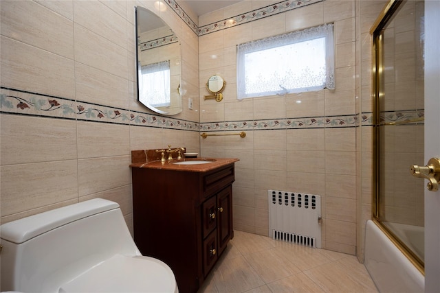 full bathroom featuring bath / shower combo with glass door, toilet, radiator heating unit, tile patterned floors, and tile walls