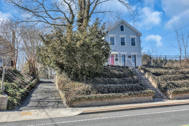 obstructed view of property with stairway and fence