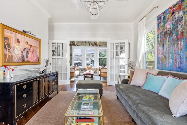 living room featuring dark wood-style floors, french doors, a notable chandelier, and crown molding