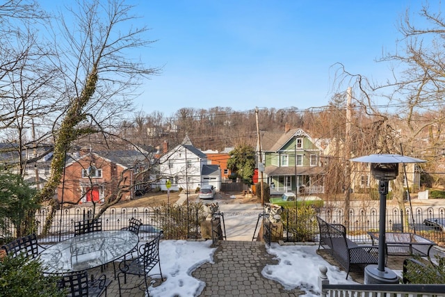 view of patio featuring a fenced front yard and a residential view