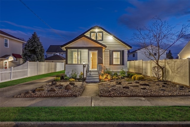 bungalow-style house with fence