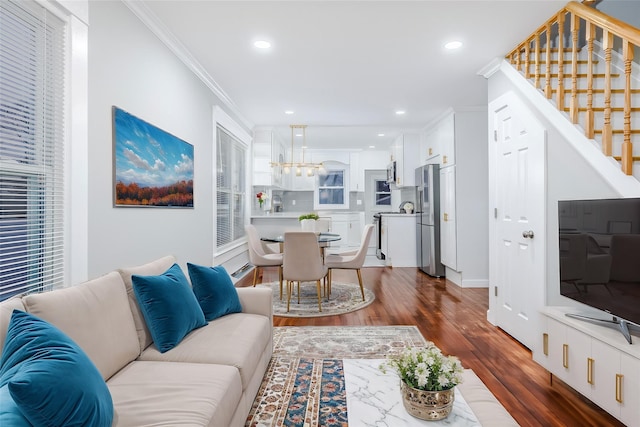 living area featuring ornamental molding, dark wood-type flooring, stairway, and recessed lighting