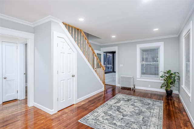 interior space with ornamental molding, stairway, wood finished floors, and radiator