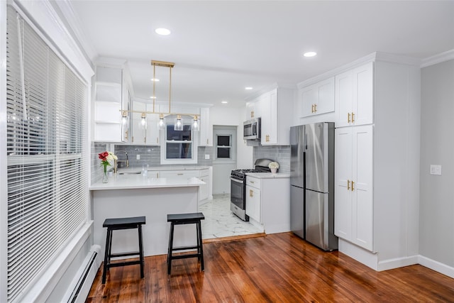 kitchen featuring a baseboard heating unit, a peninsula, a sink, appliances with stainless steel finishes, and open shelves