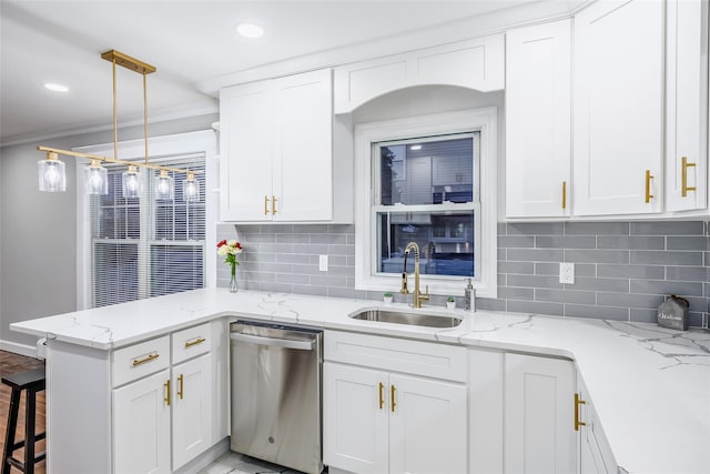 kitchen featuring a peninsula, stainless steel dishwasher, a sink, and white cabinets