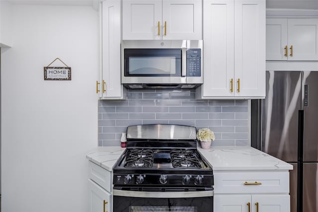 kitchen featuring appliances with stainless steel finishes, backsplash, and white cabinetry