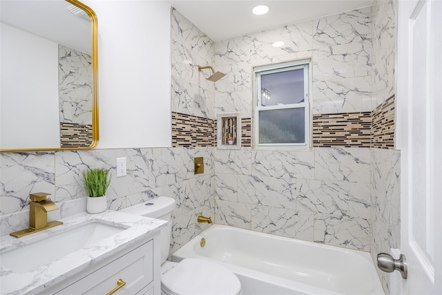 full bath featuring toilet,  shower combination, tile walls, and vanity