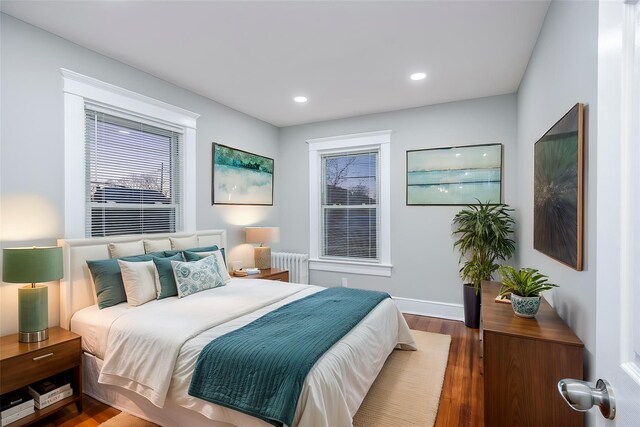 bedroom featuring radiator, baseboards, wood finished floors, and recessed lighting