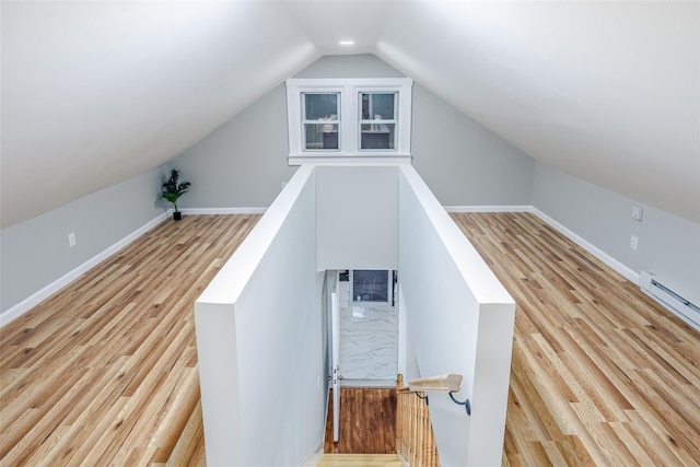 stairs with vaulted ceiling, wood finished floors, and baseboards