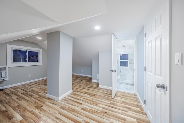 additional living space with lofted ceiling, recessed lighting, light wood-style flooring, and baseboards