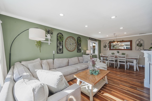 living room with a notable chandelier, recessed lighting, wood finished floors, visible vents, and ornamental molding