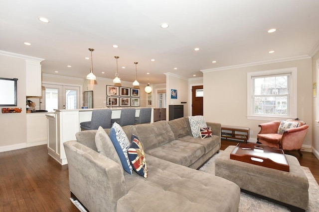 living room featuring baseboards, ornamental molding, dark wood-type flooring, and recessed lighting