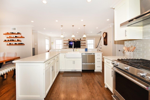 kitchen with dark wood-style floors, tasteful backsplash, white cabinetry, wall chimney range hood, and high end stove