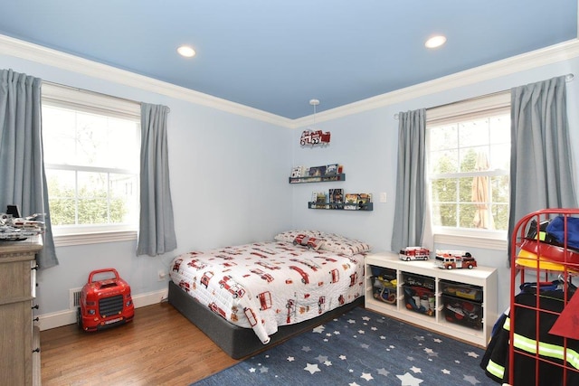 bedroom featuring baseboards, ornamental molding, wood finished floors, and recessed lighting