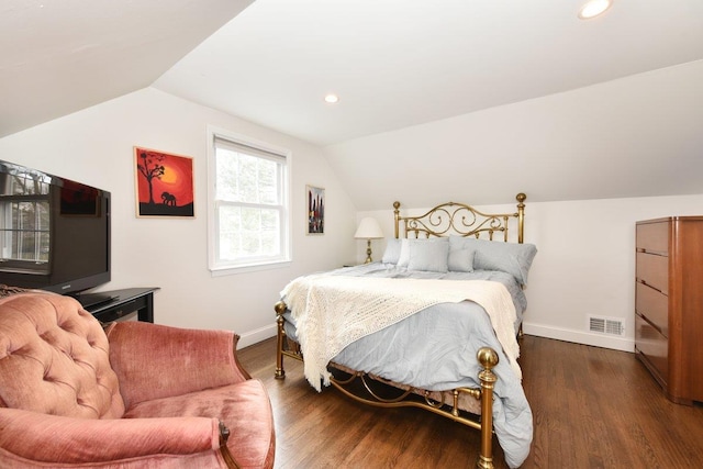 bedroom featuring visible vents, vaulted ceiling, baseboards, and wood finished floors