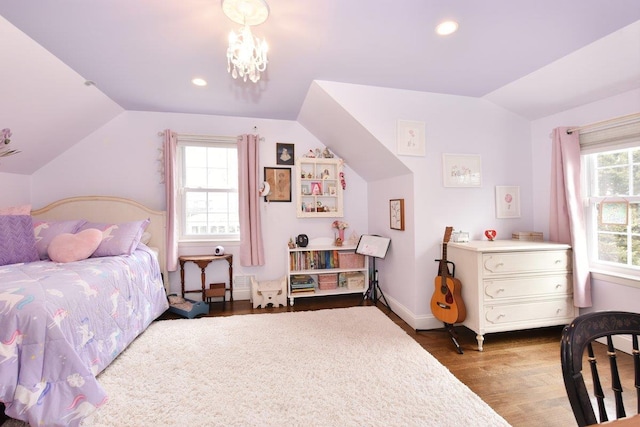 bedroom featuring lofted ceiling, recessed lighting, wood finished floors, and a chandelier